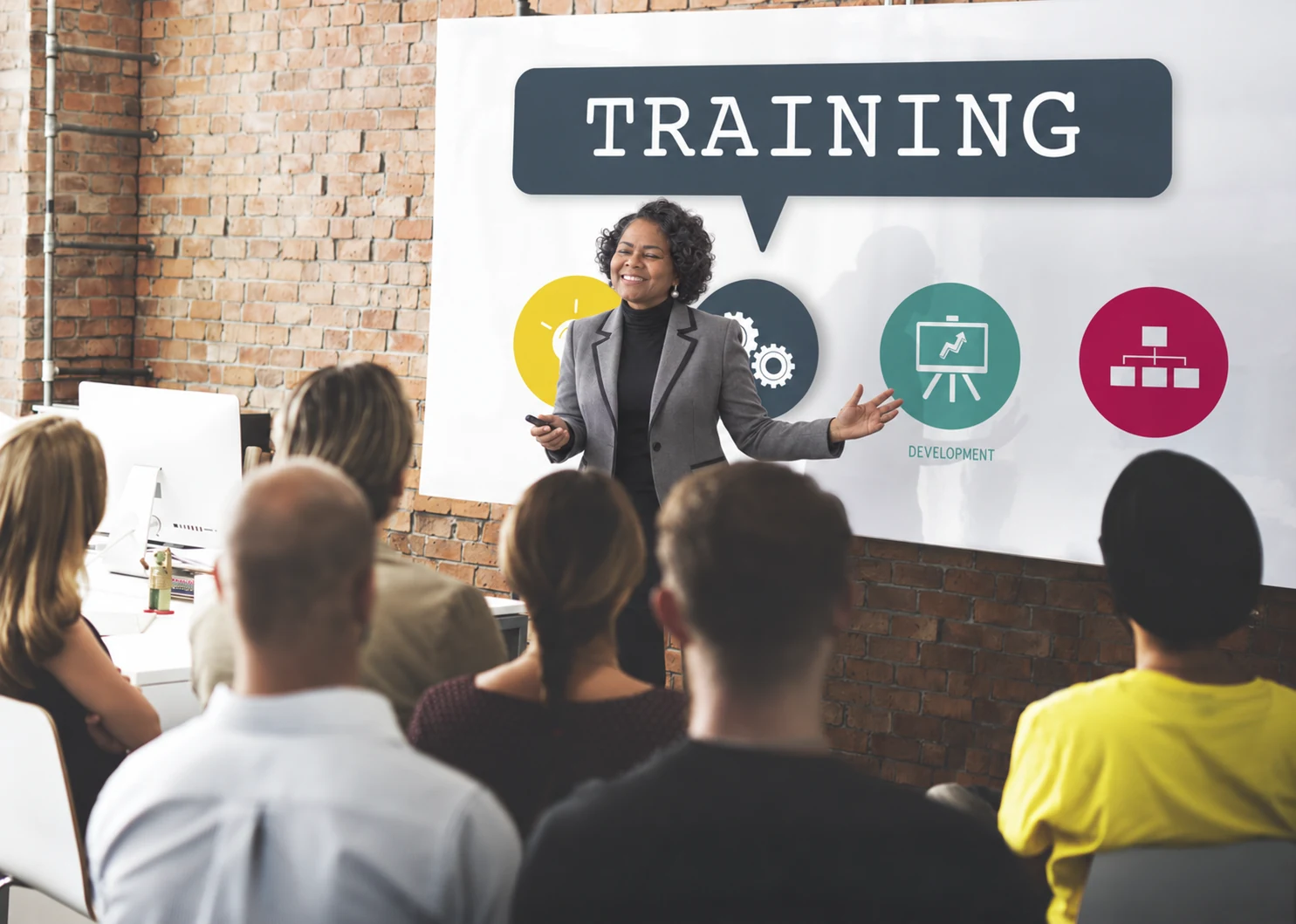 Edited illustration of Brinda Devine presenting a training session